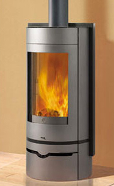 EDILKAMIN modelo VOGUE  6 Kw. Plano fuego de fundición y fuego de refractario.Posibilidad salida humos superior / posterior.Troncos de leña de máximo 50 cm verticales.Salida humos Ø 15 cm.Con cajón para la leña.Revestimiento de acero bicolor: gris antraci